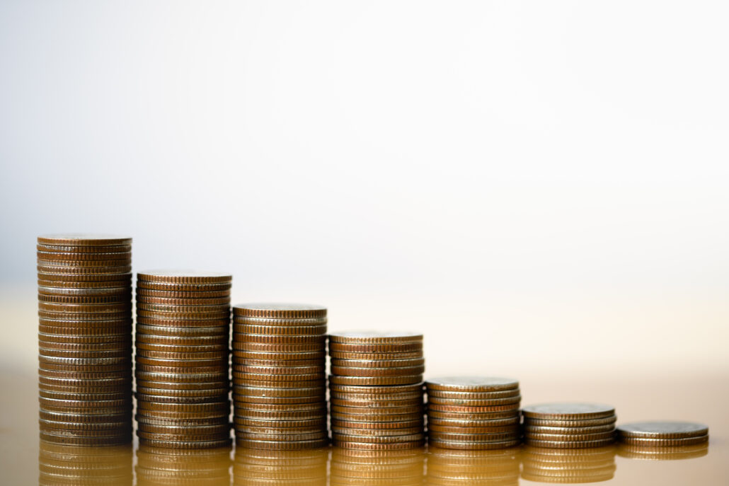 Stacked coins arranged in rising columns symbolizing long-term tax-free growth from Roth conversions.