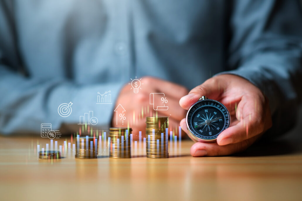 Person holding a compass next to stacks of coins and growth charts representing retirement tax planning decisions