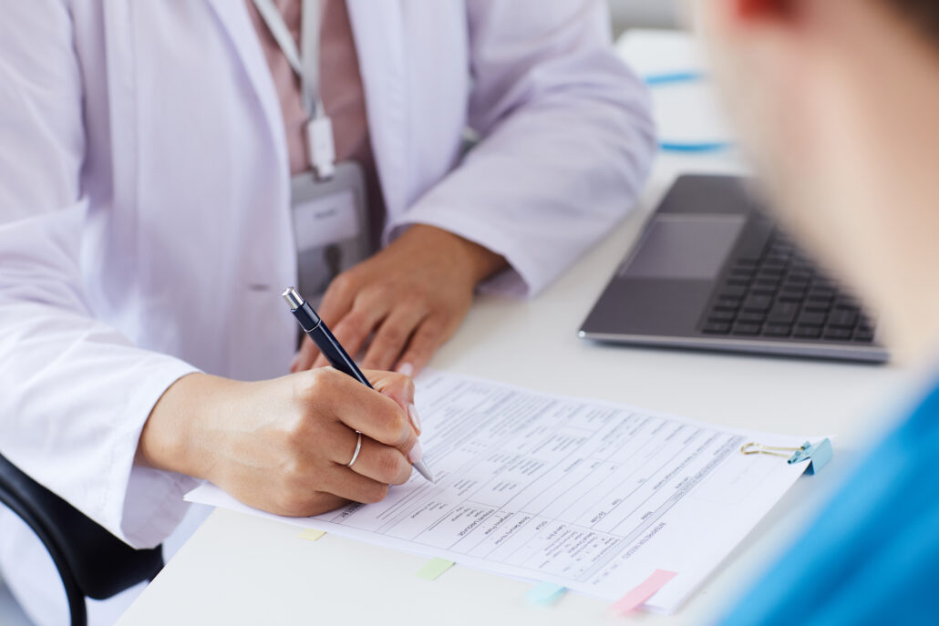 Physician reviewing paperwork during a consult about 1099 vs W-2 pay and physician tax planning