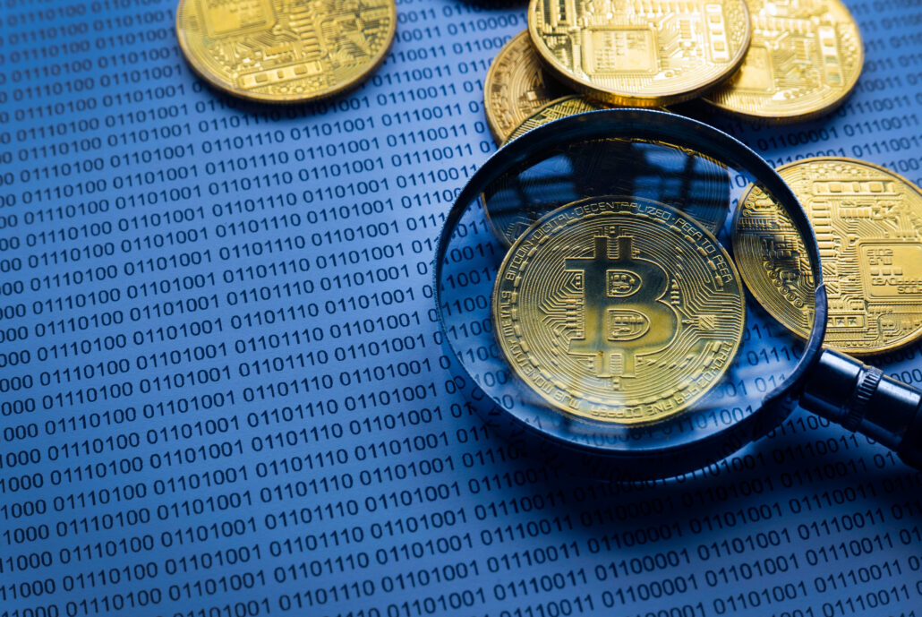 bitcoin tax planning physicians reviewing Bitcoin gains and losses with magnifying glass