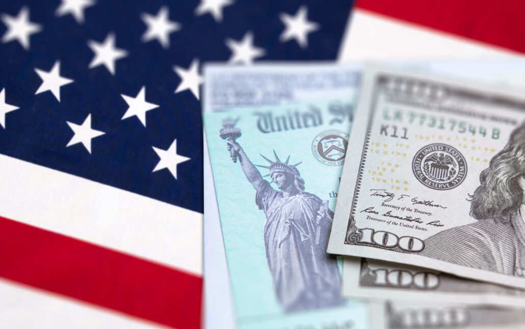 U.S. flag with U.S. currency and tax document, representing physician tax planning and high-income tax planning.